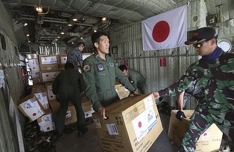 Indonesian and Japan military personnel unload relief aid from a Japan Air Force cargo plane at the Mutiara Sis Al-Jufri airport in Palu, Central Sulawesi, Indonesia. (Photo | AP)