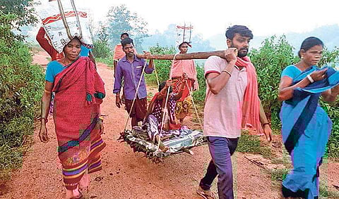 A pregnant woman of Lachhamipur village being carried by her family members. | Express Photo Services