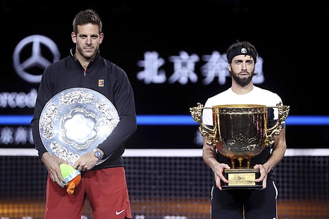 Juan Martin del Potro of Argentina, left, and Nikoloz Basilashvili of Georgia stand with their trophies after the men's singles final in the China Open at the National Tennis Center in Beijing. (Photo | AP)