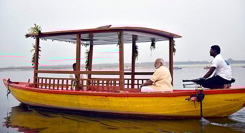 Prime Minister Narendra Modi takes a ride on the first solar powered e-boat in Varanasi. (Photo| PTI)