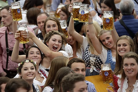 FILE-In this Oct. 7, 2018 file photo young women lift glasses of beer during the opening of the 185th 'Oktoberfest' beer festival in Munich, Germany. (Photo | AP)