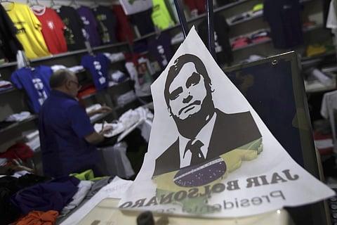 A sticker with the image of Jair Bolsonaro, presidential candidate for the National Social Liberal Party, on the counter of a shop in the neighborhood of Nucleo Bandeirante, near the center of Brasilia, Brazil. (Photo | AP)