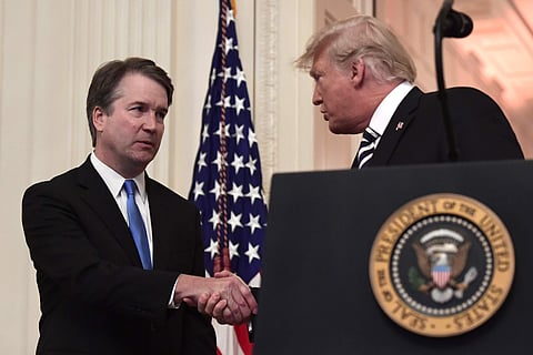 President Donald Trump, right, shakes hands with Supreme Court Justice Brett Kavanaugh, left, before a ceremonial swearing in in the East Room of the White House in Washington, Monday, Oct. 8, 2018. (Photo | AP)