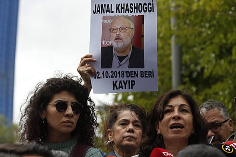 Activists, members of the Human Rights Association Istanbul branch, holding posters with photos of missing Saudi journalist Jamal Khashoggi, talk to members of the media, during a protest in his support near the Saudi Arabia consulate in Istanbul, Tuesday