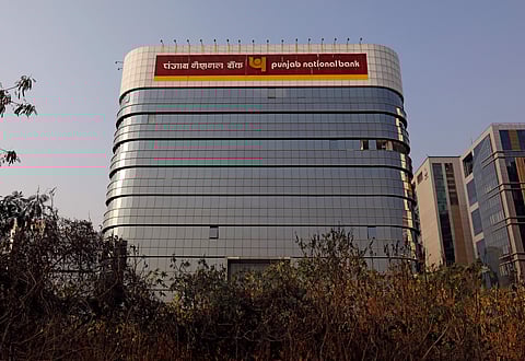 The logo of Punjab National Bank is seen on the facade of its office in Mumbai. (Photo | Reuters)