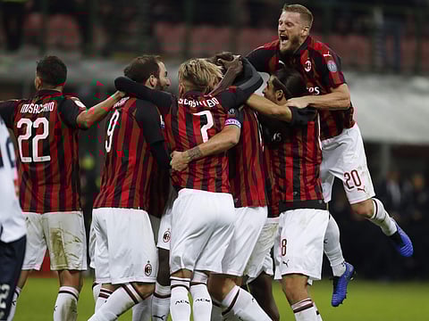 AC Milan players celebrate after Alessio romagnoli scored his side' second goal during the Serie A soccer match between AC Milan and Genoa at the San Siro Stadium in Milan, Italy, Wednesday, Oct. 31, 2018. | AP