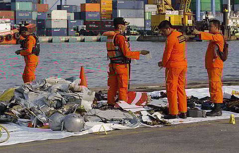 Members of Indonesian Search and Rescue Agency inspect debris recovered from near the waters where a Lion Air passenger jet is suspected to crash, at Tanjung Priok Port in Jakarta | AP