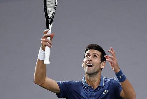 Serbia's Novak Djokovic celebrates after defeating Bosnia and Herzegovina's Damir Dzumhur during their third round match of the Paris Masters | AP