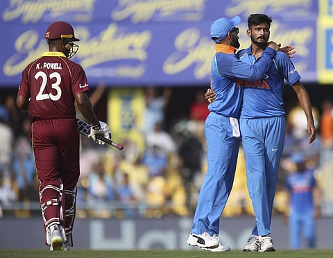 India's Khaleel Ahmed, right, celebrates with a teammate the dismissal of West Indies' batsman Kieran Powell, left, during the first ODI between India and West Indies in Gauhati, India, Sunday, October 21, 2018. | AP