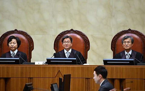 South Korea's Supreme Court chief justice Kim Myeong-su (C) delivers the court's ruling on a conscientious objector's conviction of refusing to do mandatory military service, at the court in Seoul on November 1, 2018. (Photo | AFP)
