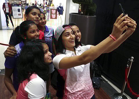 Indian shuttler Ashwini Ponnappa takes a selfie with fans in Mumbai | PTI