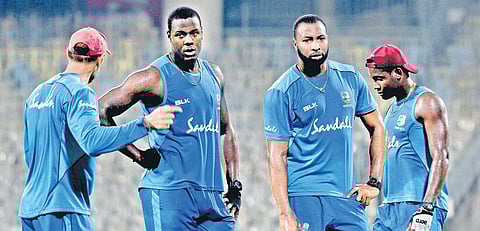 West Indies captain Carlos Brathwaite (second left) with fielding coach Nic Pothas (left), Kieron Pollard and Shimron Hetmyer | D SaMPATHKUMAR