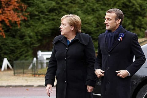 French President Emmanuel Macron and German Chancellor Angela Merkel arrive for a French-German ceremony in the clearing of Rethondes (the Glade of the Armistice) in Compiegne, northern France, on November 10, 2018 as part of commemorations marking the 10