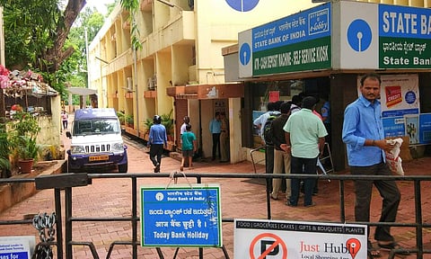 People waiting in front of an State Bank e-Corner for cash transactions at Hubli,Karnataka./ (File photo | EPS)