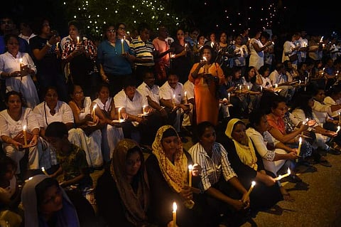 Supporters of ousted Sri Lanka's Prime Minister Ranil Wickremesinghe hold candles during a protest in Colombo on November 11, 2018. Sri Lanka's parliamentary Speaker on November 11 accused President Maithripala Sirisena of 'usurping' the rights of legisla