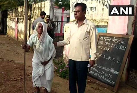 The old woman was helped by her son as she visited the polling booth set up near her house. | Image: ANI