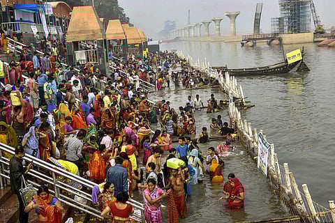 Devotees take a holy dip in the Ganga river during Nahay Khay Puja of the Chhath Puja festival in Patna. (Photo | PTI)