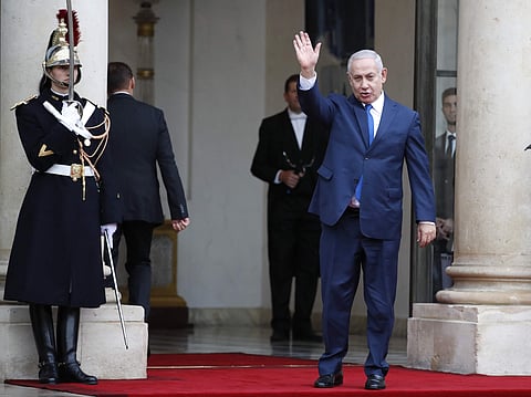 Israeli Prime Minister Benjamin Netanyahu waves as he arrives at the Elysee Palace in Paris for a lunch after participating in a World War I Commemoration Ceremony, Sunday Nov. 11, 2018. International leaders are taking place in a ceremony in Paris on Sun