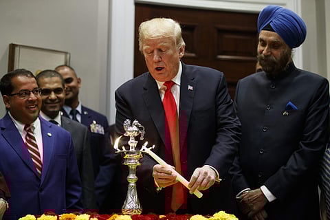 President Donald Trump participates in a Diwali ceremonial lighting of the Diya in the Roosevelt Room of the White House, Tuesday, Nov. 13, 2018, in Washington. | AP