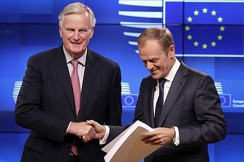 EU chief Brexit negotiator Michel Barnier, left, delivers the draft withdrawal agreement to European Council President Donald Tusk during a media conference (Photo | AP)