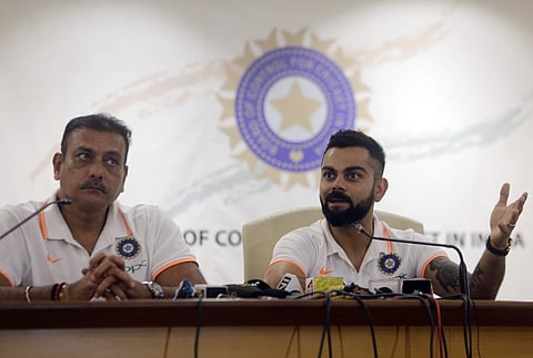 Indian cricket captain Virat Kohli speaks with head coach Ravi Shastri by his side before the team's departure for their Australia tour, in Mumbai, India. (Photo | AP)