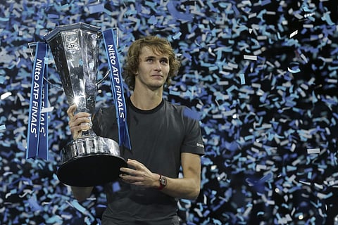 Alexander Zverev of Germany holds the trophy after defeating Novak Djokovic of Serbia in their ATP World Tour Finals singles final tennis match at the O2 Arena in London. (Photo: AP)