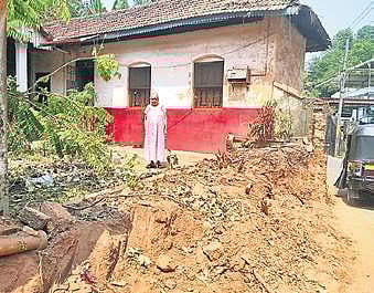 Lakshmidevi Pai in front of her house