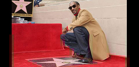 Musician Snoop Dogg poses next to his Hollywood Walk of Fame star. (Photo | AP)