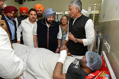 Punjab Chief Minister Capt Amarinder Singh visits a victim of the grenade blast at Nirankari Bhavan at a hospital in Amritsar Monday Nov. 19 2018. | PTI