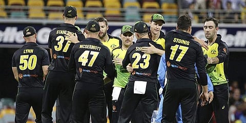 Australia players celebrate after winning the first T20 International cricket match between Australia and India in Brisbane, Australia. ( Photo| AP)