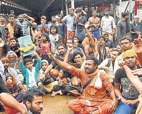 Devotees and their children protesting the SC verdict allowing women’s entry into temple outside the Sabarimala shrine (File photo | EPS)
