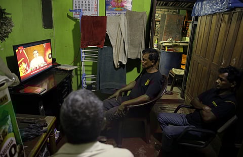 FILE - In this Oct. 28, 2018 file photo, Sri Lankans watch a televised speech by president Maithripala Sirisena at their residence in Colombo, Sri Lanka. Two men each claim to be the prime minister. Lawmakers are exchanging blows in Parliament. (Photo | A