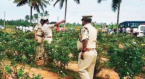 Police inspect the farm land where the body of Harish was  found | express