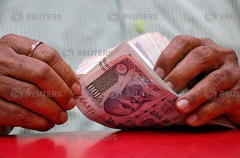 A man counts Indian currency notes inside a shop in Mumbai, August 13, 2018. (Photo | REUTERS)