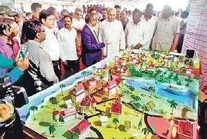 Chief Minister Naveen Patnaik interacts with officials after laying the foundation stone for Basudha scheme at Gomundia in Krushnaprasad block of Puri district | Ranjan Ganguly