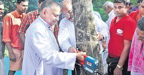 The machine has a sensor that helps the farmer gauge the depth of the cut being made on the tree