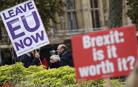 Pro and anti Brexit protesters hold placards as they vie for media attention near Parliament in London. (Photo| AP)