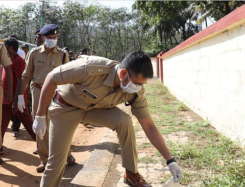 SP Yathish Chandra removing plastic as part of the cleaning drive at Nilakkal in Sabarimala on Friday (Photo | EPS/Melton Antony