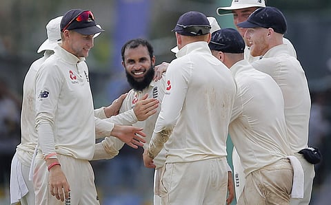 England's Adil Rashid, center facing camera, is congratulated by his teammates for taking the wicket of Sri Lanka's Malinda Pushpakumara during the second day of the third test cricket match between Sri Lanka and England in Colombo, Sri Lanka. (Photo | AP