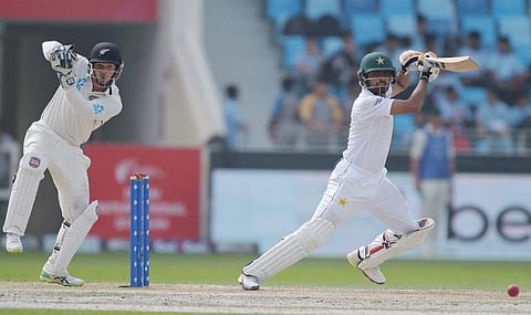 Pakistani batsman Babar Azam (R) plays a shot as New Zealand wicketkeeper BJ Watling looks on during the second day of the second Test cricket match between Pakistan and New Zealand at the Dubai International Stadium in Dubai on November 25, 2018. | AFP