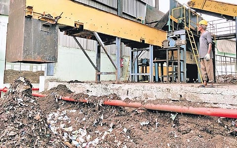 A worker operates a shredder at the waste management facility run by Essel Group. | Express Photo Services