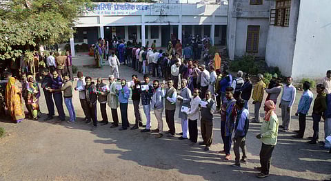 People wait with their identity cards to cast their votes for the Assembly elections in Jabalpur. (Photo|PTI)