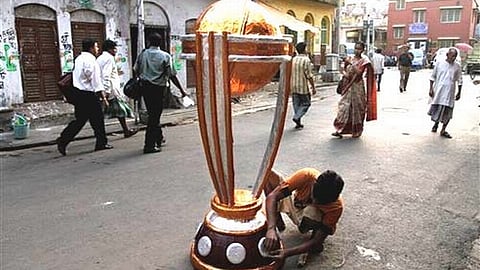 An Indian artist gives finishing touches to a replica of the cricket World Cup trophy in Kolkata, India . (Photo| AP)