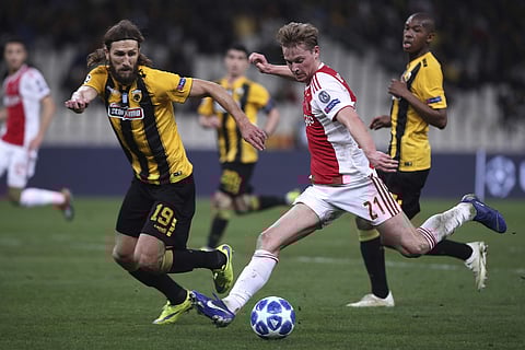 AEK's Dmytro Chygrynskiy (L) fights for the ball with Ajax's Frenkie de Jong during a Group E Champions League match at the Olympic Stadium in Athens | AP