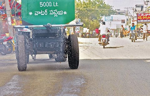 Water being sprinkled on the roads in Jammikunta to reduce dust | EXPRESS PHOTO