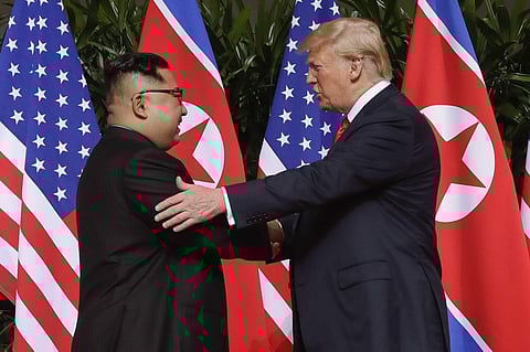 In this June 12, 2018, file photo, U.S. President Donald Trump shakes hands with North Korea leader Kim Jong Un at the Capella resort on Sentosa Island. (Photo | AP)