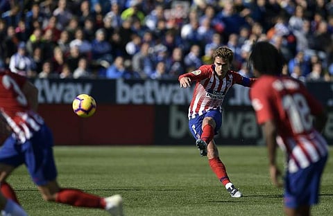 Atletico Madrid's French forward Antoine Griezmann shoots to score the opening goal against Leganes | AFP