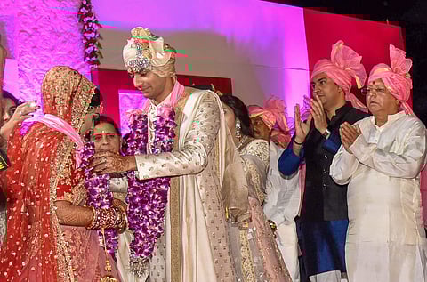 RJD chief Lalu Prasad's elder son Tej Pratap and Aishwarya Rai during their wedding ceremony at Veterinary College Ground in Patna on Saturday. (PTI)