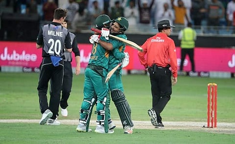 Pakistan's Mohammed Hafeez (R) and Sarfraz Ahmed (L) celebrate with team mates at the end of T20 cricket cricket match between Pakistan and New Zealand at the Dubai Cricket Stadium in Dubai on November 2, 2018. | AFP