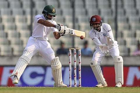 Bangladesh's Shadman Islam (L) plays a shot as West Indies's wicketkeeper Shane Dowrich watches during the first day of the second Test in Dhaka. | AFP